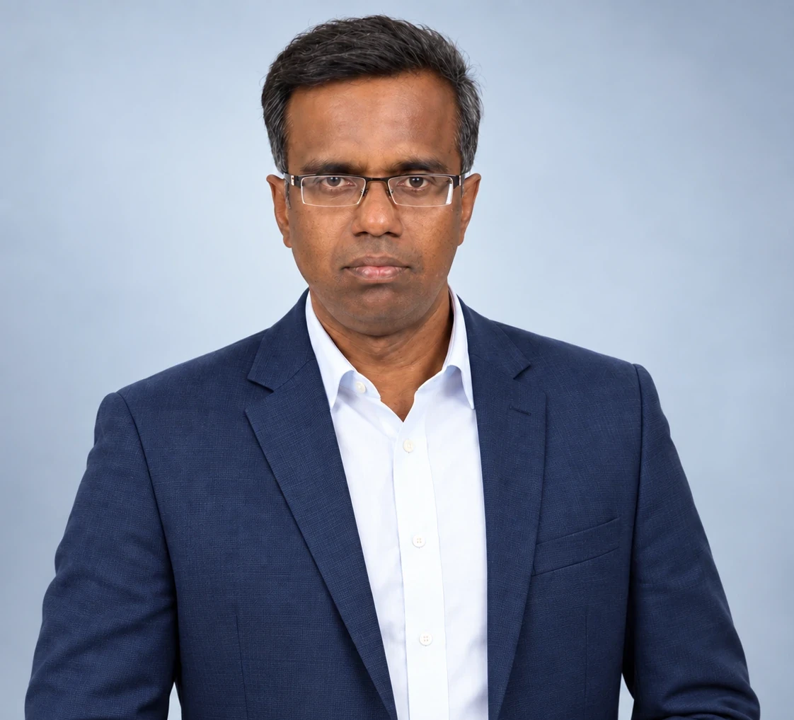 Ravi Chandran, Aimerix Co-Founder and Principal Consultant, wearing a navy-blue blazer